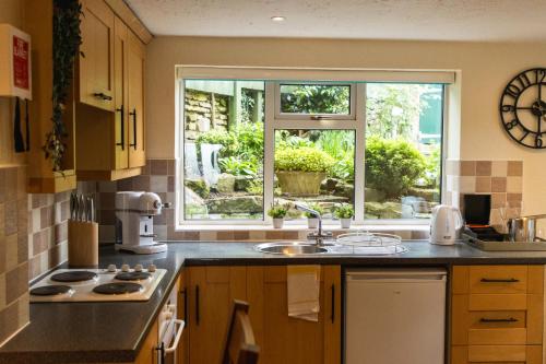 a kitchen with a sink and a window at The Peacock at Barlow in Chesterfield