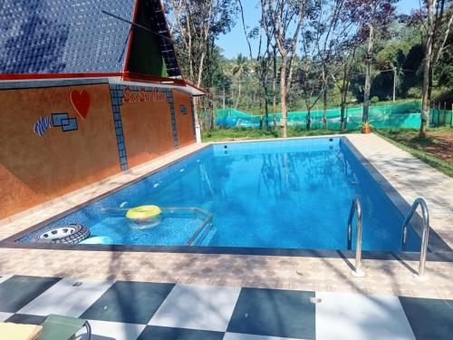 a pool in a backyard with a swimming pool at SanSree's Puzhakkal Homestay in Wayanad