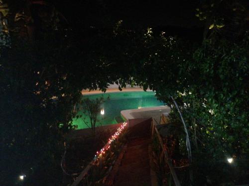 a swimming pool at night with a lit up sidx sidx sidx sidx sidx at Villa Garita Inn in La Garita