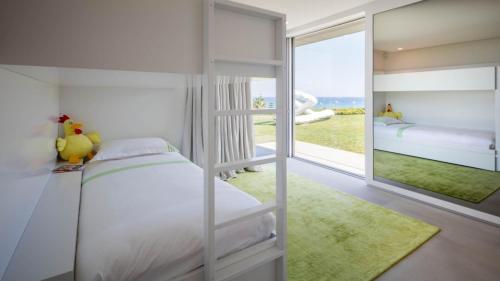 a bedroom with a bunk bed and a view of the ocean at Amamia in Saint-Tropez