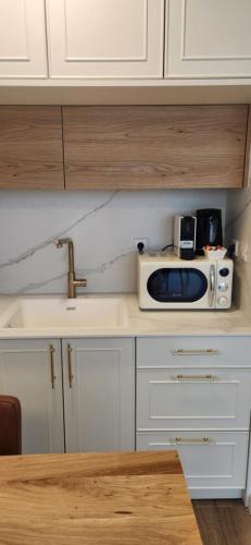 a kitchen with a microwave on top of a counter at מול הים בקיסריה in Caesarea