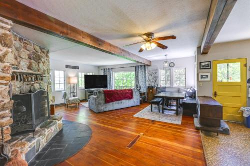 a living room with a fireplace and a stone wall at On-Site River Access Quiet Home in Wilseyville! in Wilseyville