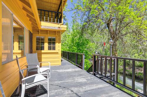 a porch of a yellow house with chairs on it at On-Site River Access Quiet Home in Wilseyville! in Wilseyville