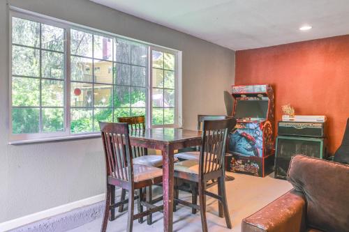 a dining room with a table and chairs and windows at On-Site River Access Quiet Home in Wilseyville! in Wilseyville
