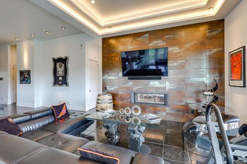 a living room with a couch and a table at Motorcycle-Themed Home in Spearfish with Hot Tub! in Spearfish
