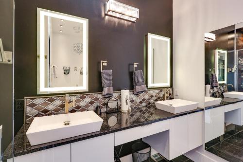 a bathroom with two sinks and two mirrors at Motorcycle-Themed Home in Spearfish with Hot Tub! in Spearfish