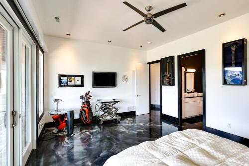 a bedroom with a bed and a ceiling fan at Motorcycle-Themed Home in Spearfish with Hot Tub! in Spearfish
