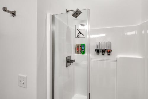 a white refrigerator with a glass door in a kitchen at Motorcycle-Themed Home in Spearfish with Hot Tub! in Spearfish