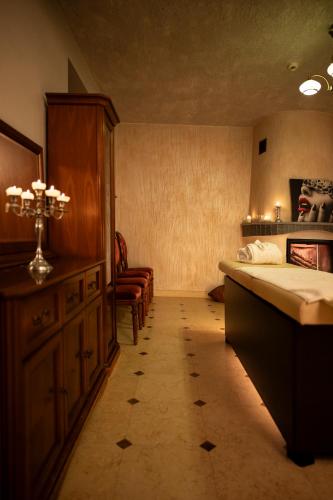 a bedroom with a bed and a cabinet and a chair at Zamek Dubiecko in Dubiecko