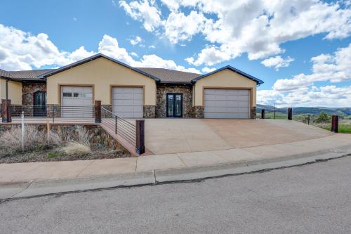 a house with a large driveway at Motorcycle-Themed Home in Spearfish with Hot Tub! in Spearfish
