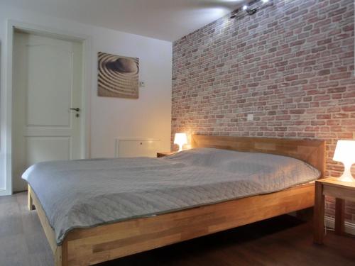 a bedroom with a brick wall and a bed at Ferienwohnung MH1 "Blue Ocean" in Rostock