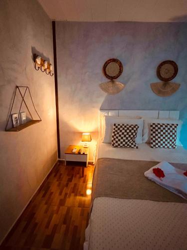 a bedroom with a large bed and a wooden floor at Martinelli Residence in Fernando de Noronha