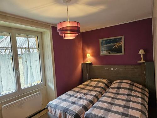 a bedroom with a bed and a window at LA FRACELINE in Saint-Pierre-dʼEntremont