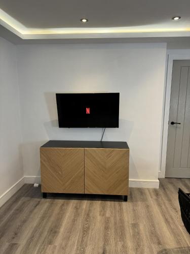 a living room with a tv on a wall at Central Hull Apartments in Hull