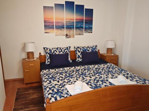 a bedroom with a bed and two night stands with two lamps at Apartman Vera in Crikvenica