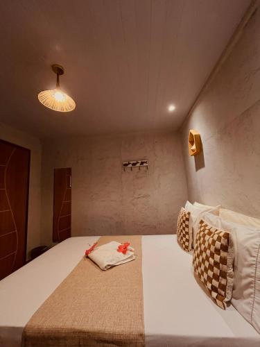 a bedroom with a large white bed in a room at Martinelli Residence in Fernando de Noronha