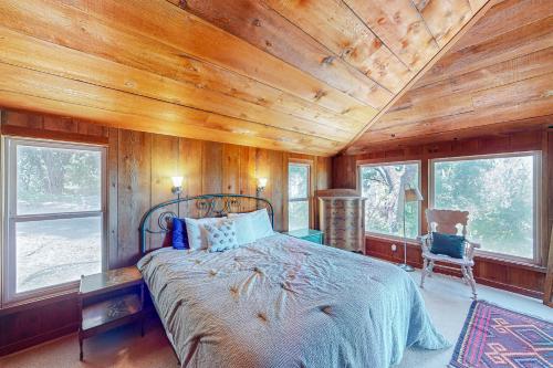 a bedroom with a bed in a room with wooden walls at Casa Pinostella in Templeton