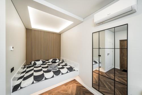 a bedroom with a black and white bed at Riverra House - Studio Panorama View in Kaunas