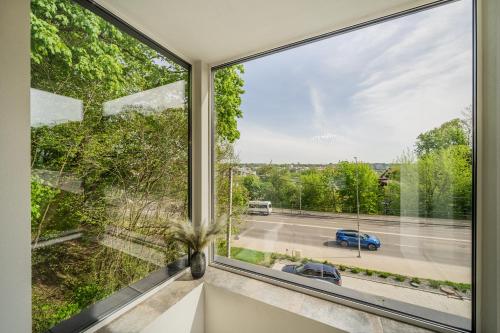 a large window in a room with a view of a street at Riverra House - Studio Panorama View in Kaunas
