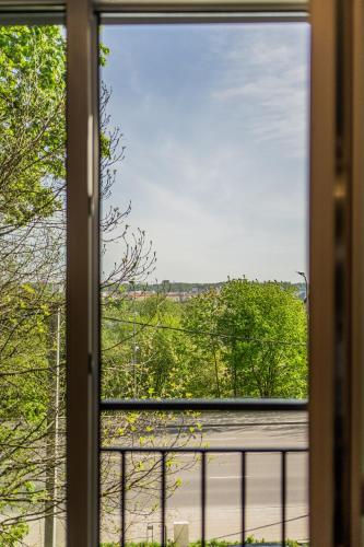 a window with a view of a street outside at Riverra House - Studio Panorama View in Kaunas