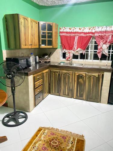 - une cuisine avec des placards en bois et une table dans l'établissement Pinevalley Rental Suites 2b ONE BEDROOM, à Mandeville