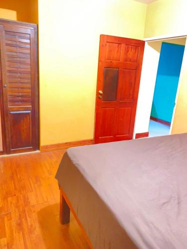 a bedroom with a bed and a wooden cabinet at Pinevalley Rental Suites 2b ONE BEDROOM in Mandeville