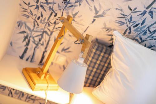 a lamp on a table next to a bed at Durango in Keitum