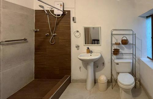 La salle de bains est pourvue de toilettes, d'un lavabo et d'une douche. dans l'établissement Casa de campo privada cerca a Chan Chan, à Trujillo