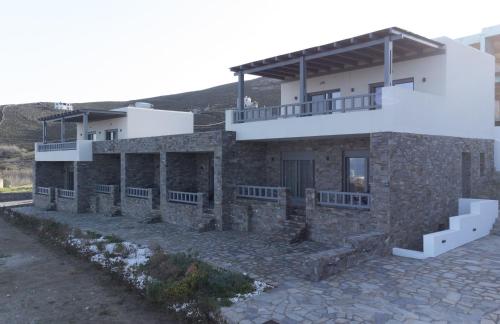 a stone house with a balcony on top of it at Aegeans Eye in Azolimnos