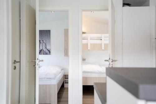 a small room with a bedroom and a bed at Ostseecamp Chalet Haffkrug No 55 in Scharbeutz