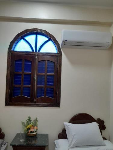 a window in a room with a bed and a table at Osiris Guest House in Abu Simbel
