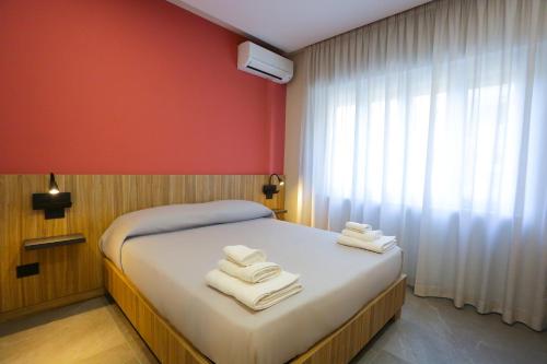 a bedroom with a bed with towels on it at RIDA 33 Vomero in Naples