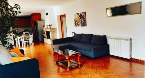 a living room with a blue couch and a table at Villa Casa Brandao in Póvoa de Varzim