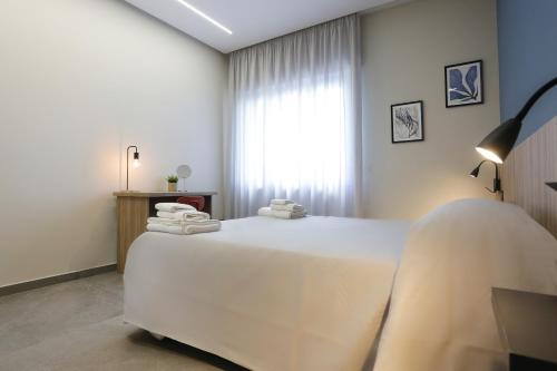 a bedroom with a white bed with towels on it at RIDA 33 Vomero in Naples