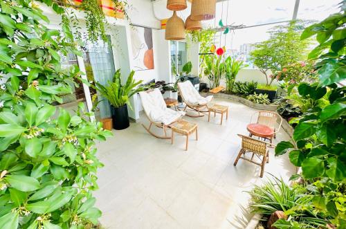 a patio with chairs and tables and plants at Skyline Penthouse Greenery in Ho Chi Minh City