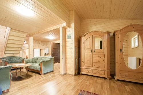 a living room with wooden walls and a table and chairs at Drevenica Rybárie in Klokočov