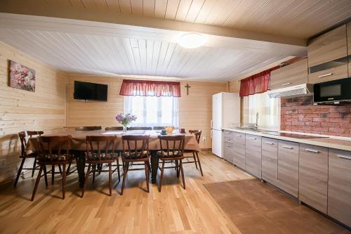 a kitchen with a table and chairs in a room at Drevenica Rybárie in Klokočov