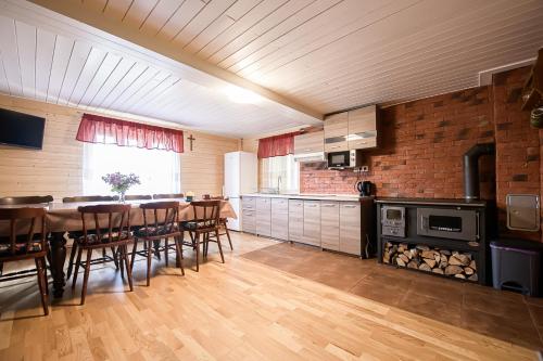 a kitchen with a table and a dining room at Drevenica Rybárie in Klokočov
