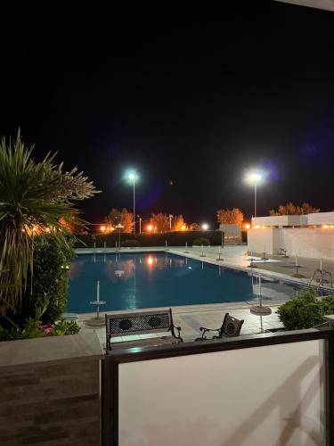 a swimming pool at night with a bench next to it at Villa con piscina L’Approdo in Barletta
