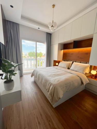 a bedroom with a large bed and a large window at Villa United Arab Emirates in Ras al Khaimah