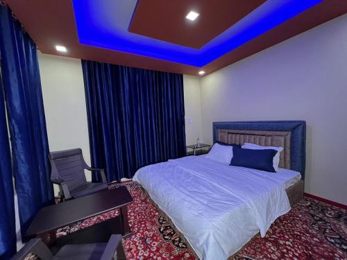 a bedroom with a bed and a blue ceiling at The GRITTI CASTLE HOTEL AND RESTAURANT in Kanzalwan