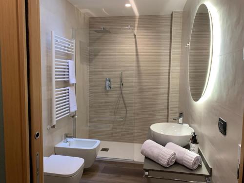 a bathroom with a sink and a toilet and a shower at Casa vacanze Clorofilla in Bergamo