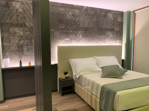 a bedroom with a bed with a headboard and a window at Casa vacanze Clorofilla in Bergamo