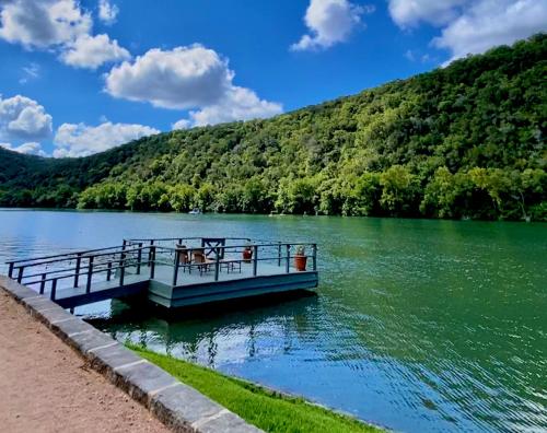 a boat on a lake with a mountain at Lake Austin Spa Resort - All Inclusive in Austin