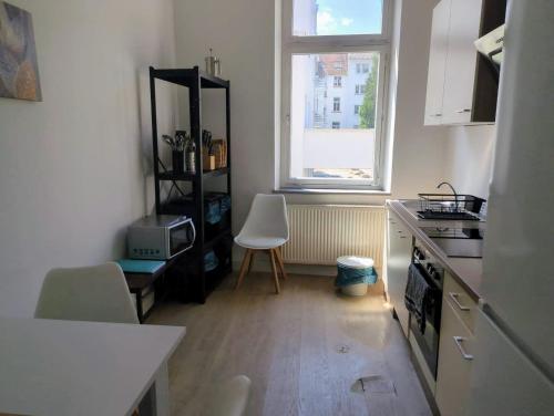 a kitchen with a table and a chair in a room at L8 Street-Worms in Worms