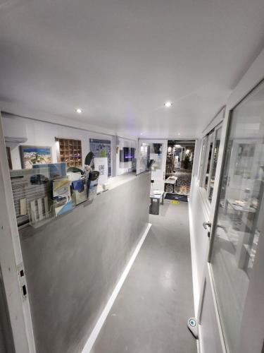 a large room with a hallway with glass windows at Zoumis Residence in Naousa