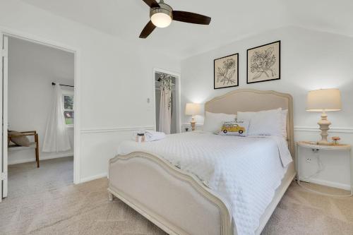 a white bedroom with a bed and a ceiling fan at Cottage Escape in Virginia Wine Country in Lovettsville