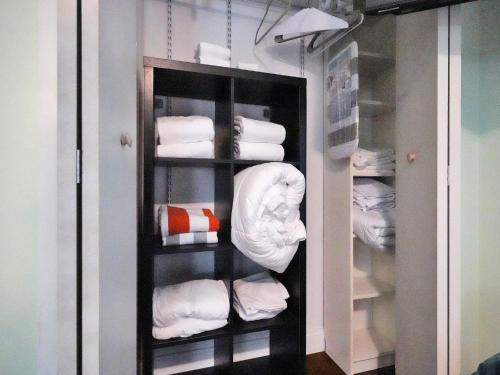 a closet filled with lots of white towels at GAYPool Side Pleasure CLOTHING OPTIONAL MENS only guesthouse in Fort Lauderdale