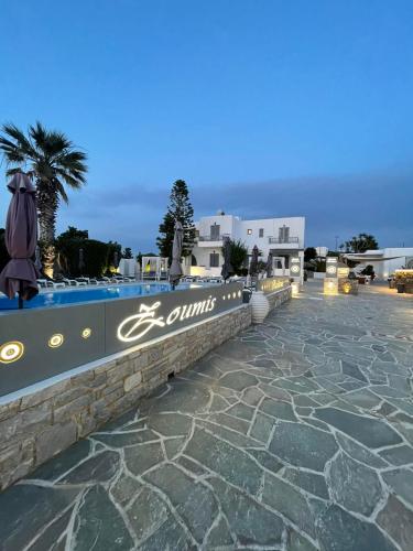 a resort with a swimming pool at night at Zoumis Residence in Naousa