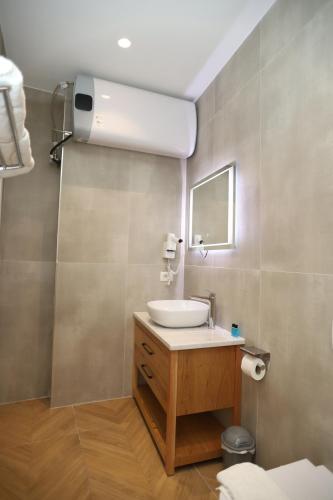 a bathroom with a sink and a mirror at J&D Rooms Korce in Korçë